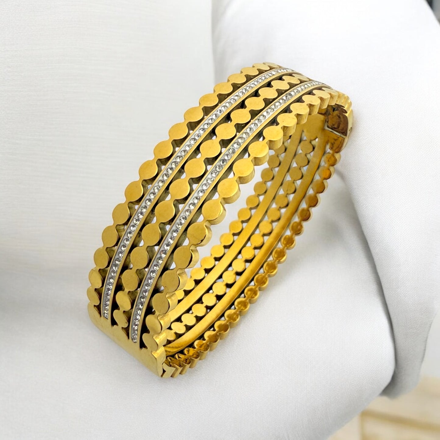 Gold-toned anti-tarnish bangle set with circular detailing and sparkling stone accents, featuring an intricate and stylish design, perfect for both modern and traditional looks. By MANKAA