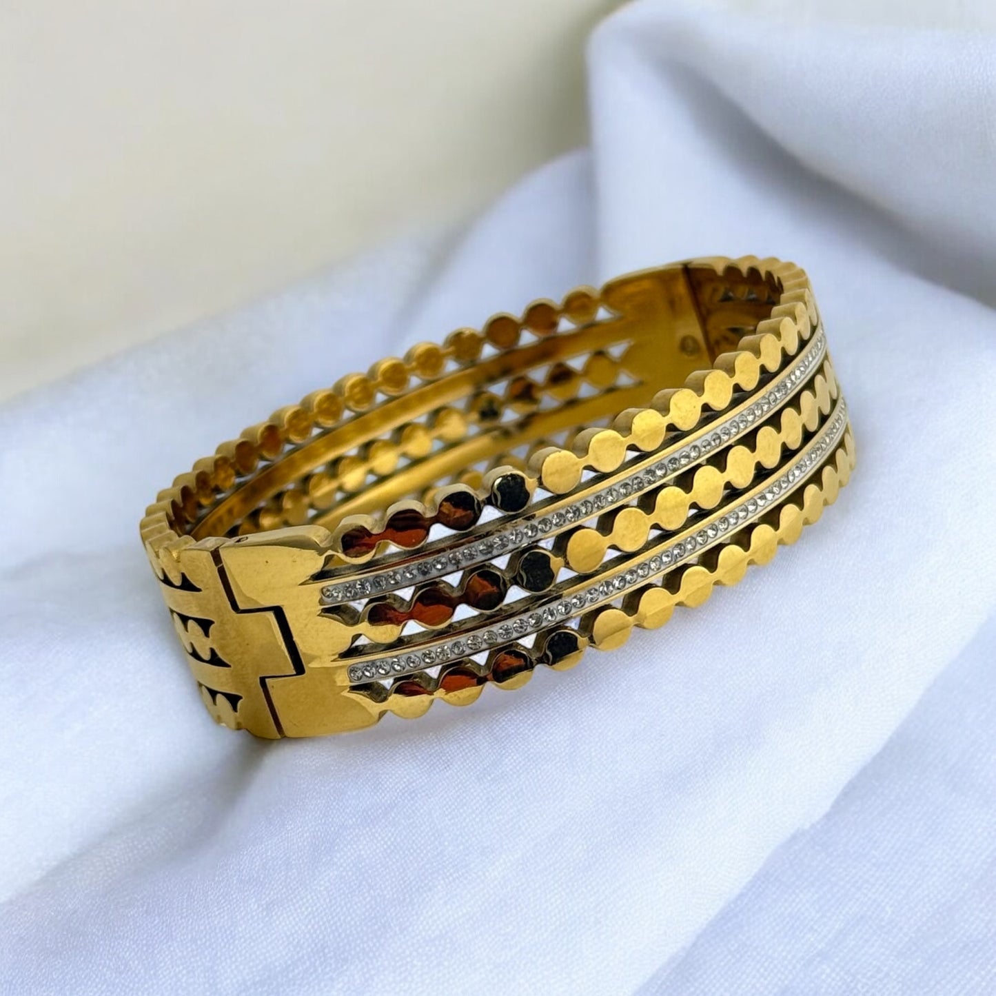 Gold-toned anti-tarnish bangle set with circular detailing and sparkling stone accents, featuring an intricate and stylish design, perfect for both modern and traditional looks. By MANKAA