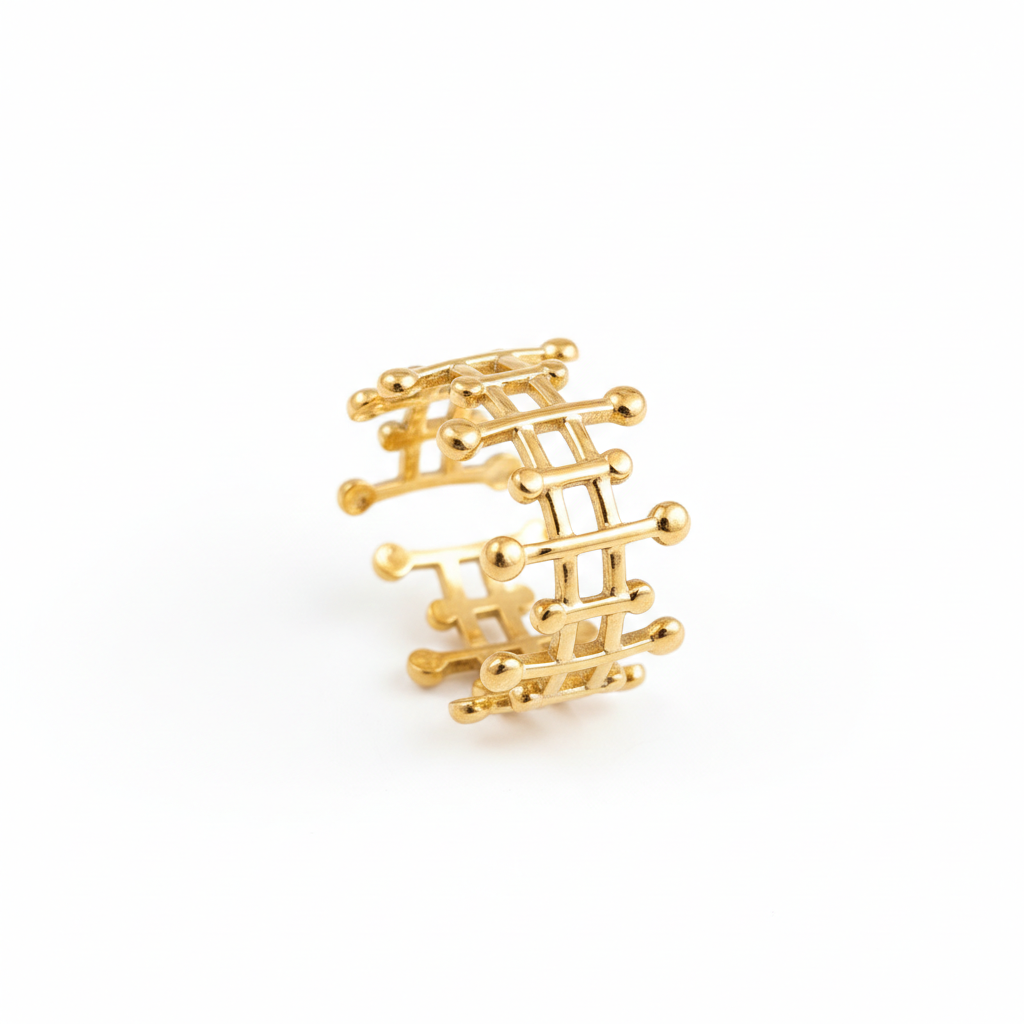 Gold ring with a geometric design on a white background