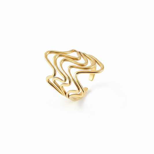 Gold ring with wavy design on a white background